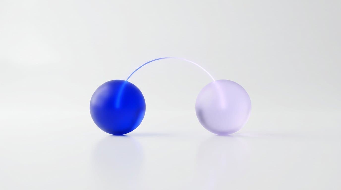 Two frosted glass spheres on a white surface, the left lit deep electric blue and the right pale, a thin light line between them